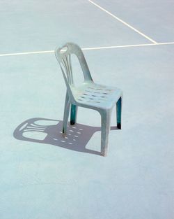 High angle view of empty chair on floor