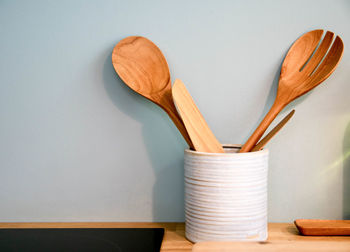 Close-up of orange table against white wall