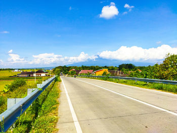 Road passing through landscape against sky