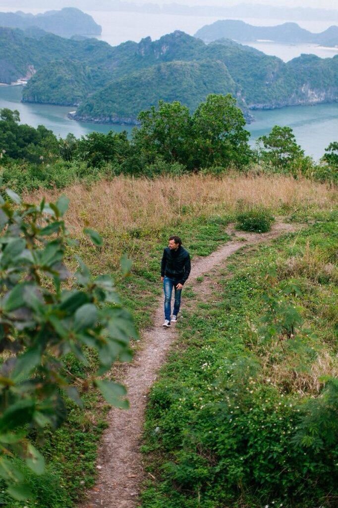 rear view, lifestyles, mountain, leisure activity, water, full length, tranquil scene, tranquility, casual clothing, nature, beauty in nature, standing, scenics, lake, person, men, grass, plant