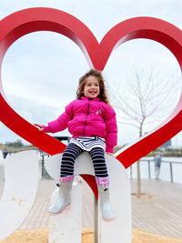 Portrait of young woman sitting on slide