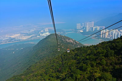 High angle view of overhead cable car on mountain against blue sky