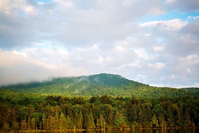 Scenic view of mountains against cloudy sky