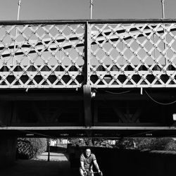 Low angle view of bridge standing on railing of building