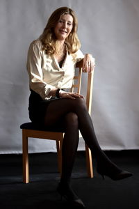 Young woman sitting on sofa at home