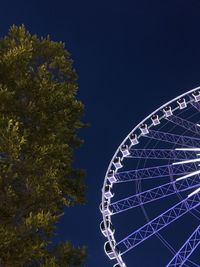 Low angle view of ferris wheel against sky at night