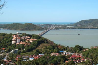 High angle view of townscape by sea against clear sky