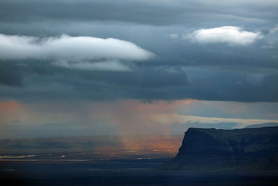 Scenic view of dramatic sky over landscape during sunset