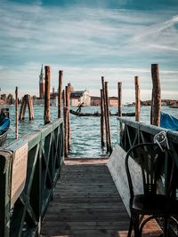 Wooden pier in sea against sky