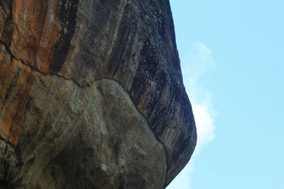 Low angle view of rock formation against sky