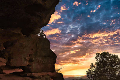 Low angle view of rock formation against sky during sunset