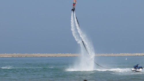 Person flyboarding in sea