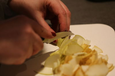 Cropped hands cutting food