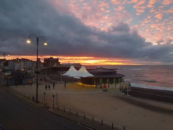 Scenic view of beach against sky at sunset