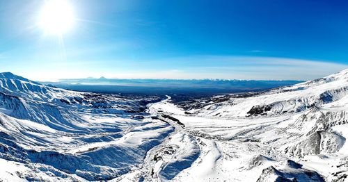 Scenic view of snowcapped mountains against blue sky