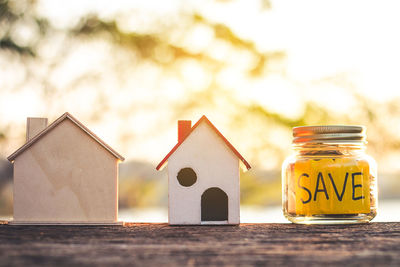 Close-up of yellow toy on table against house