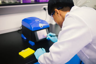 Side view of man using mobile phone