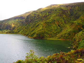 Scenic view of lake by trees against sky