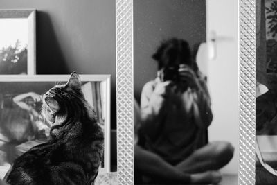 Reflection of woman in mirror at home