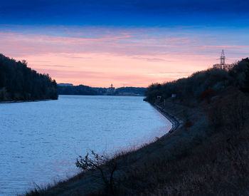 Scenic view of lake against sky during sunset