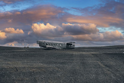 View of abandoned military plane wreck at black sand beach in solheimasandur