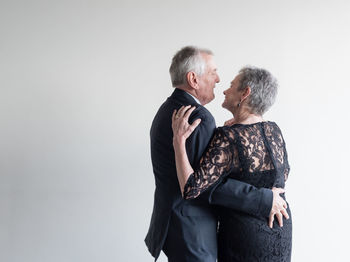 Couple kissing against white background