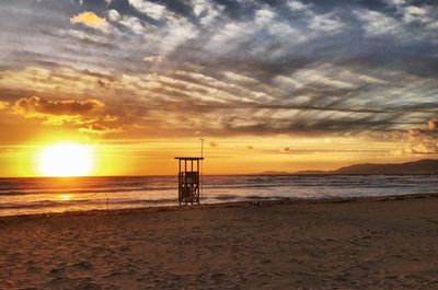 Scenic view of beach against sky during sunset