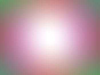 Defocused image of pink bright sun