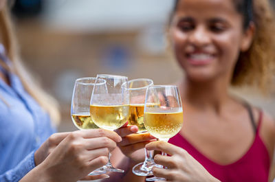 Midsection of people toasting drinks