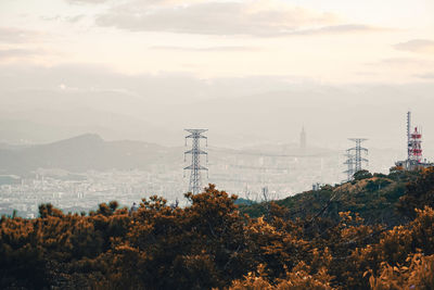 Electricity pylon on mountain against sky