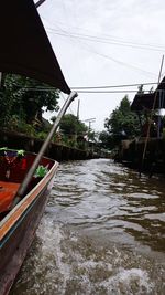Canal amidst buildings in city against sky