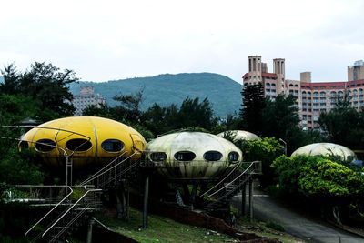 Panoramic view of railroad tracks amidst buildings against sky