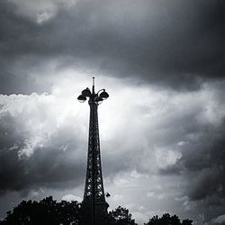 Low angle view of silhouette statue against cloudy sky