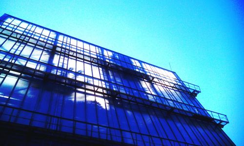 Low angle view of building against clear blue sky