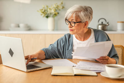 Young woman using laptop at table