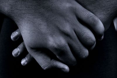 Cropped image of person with hands clasped