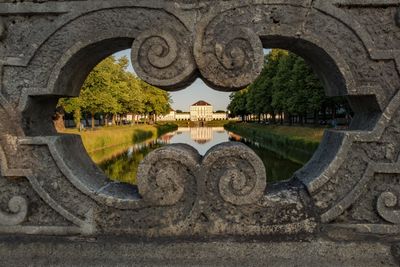 Arch bridge over river against sky