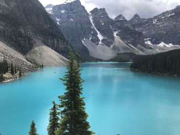 Scenic view of lake by mountains against sky