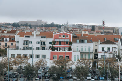 Houses in city against sky during winter