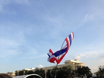 Low angle view of flag flags against sky