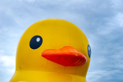 Low angle view of yellow toy against sky