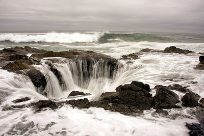 Scenic view of thor's well against grey sky