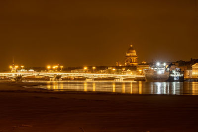 Illuminated city against sky at night