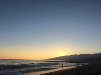 Scenic view of sea against clear sky during sunset