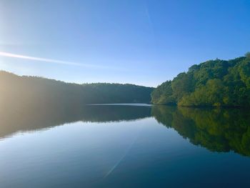 Scenic view of lake against clear blue sky