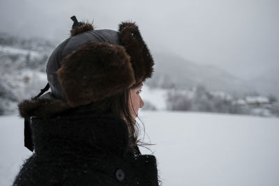 Close-up of woman wearing warm clothing on field during winter