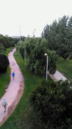 Man on golf course against sky