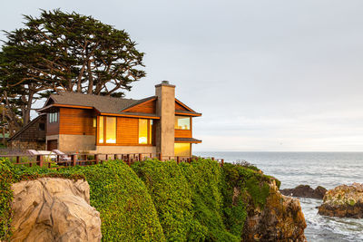 Small coastal house on the very shore of the ocean