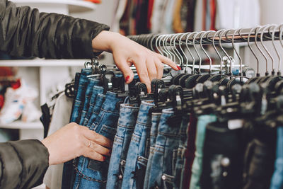 Midsection of woman in shopping cart at store