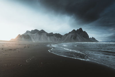 Scenic view of sea and mountains against sky